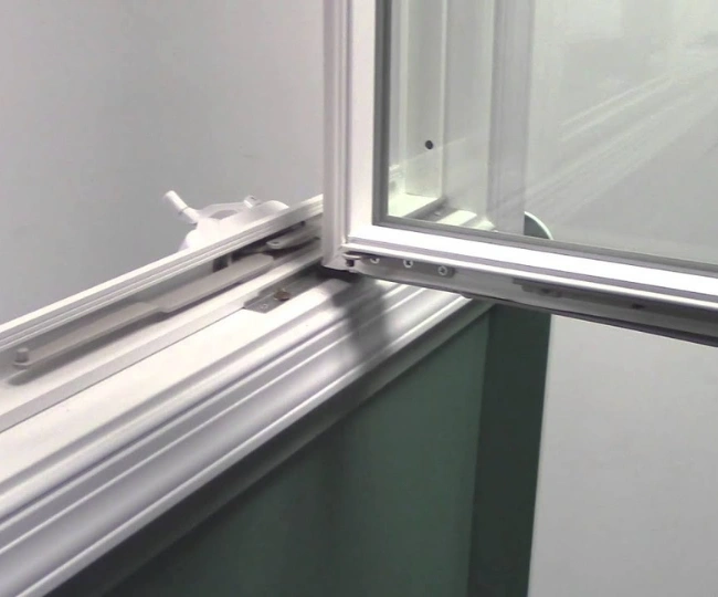 Close-up of a professional technician realigning a dropped PVC window sash in a Gibraltar residential property.