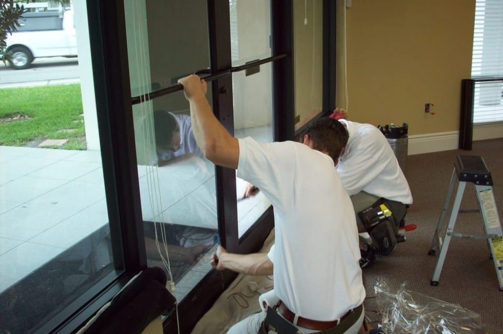 RHS technician providing rapid 24-7 emergency window boarding and toughened glass replacement for a storefront.