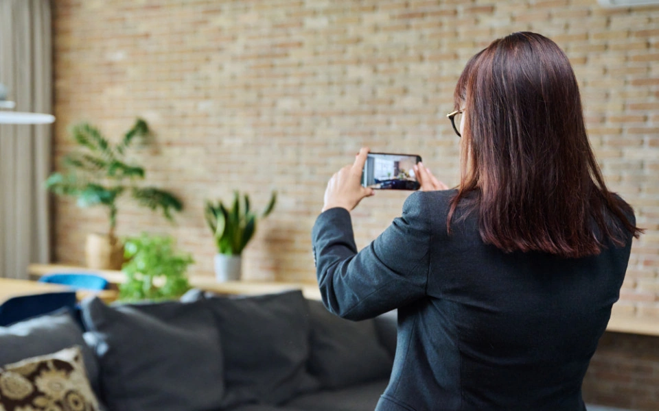 Person taking a photo of a door with a phone
